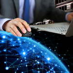 man working on laptop computer with global network graphic and server